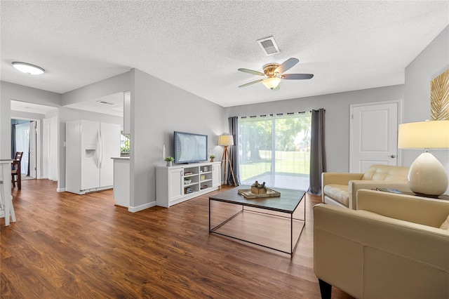 living room with a textured ceiling, ceiling fan, and hardwood / wood-style flooring