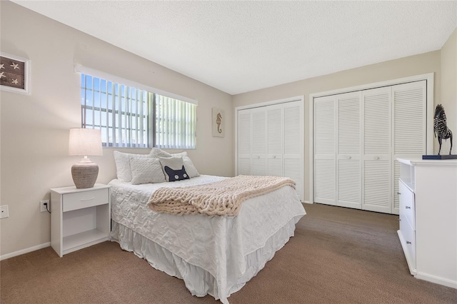 carpeted bedroom featuring two closets