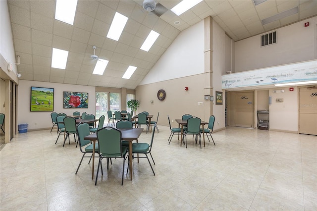 tiled dining room with high vaulted ceiling and a paneled ceiling