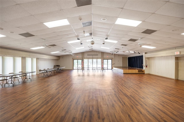 interior space with hardwood / wood-style floors, a drop ceiling, ceiling fan, and lofted ceiling