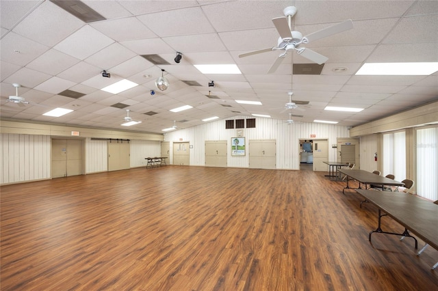 misc room with ceiling fan, hardwood / wood-style flooring, and a drop ceiling