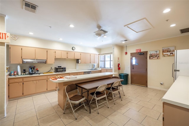 kitchen with stainless steel appliances, ceiling fan, light tile patterned floors, and a kitchen bar