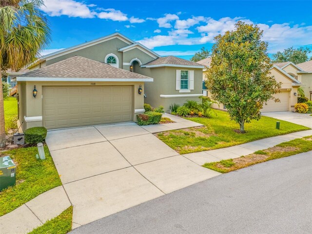 view of front of house with a garage and a front yard