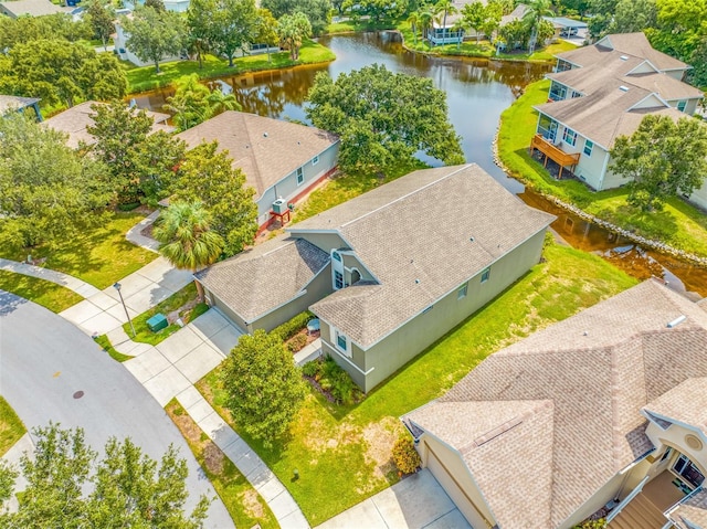 drone / aerial view featuring a water view and a residential view