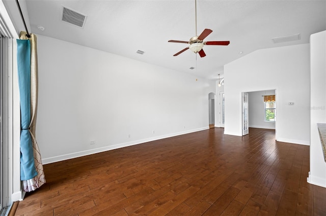 unfurnished room with arched walkways, visible vents, a ceiling fan, vaulted ceiling, and dark wood-style floors