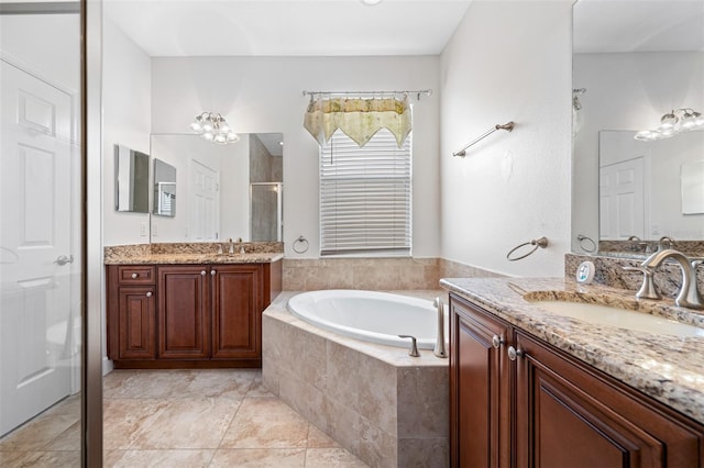 bathroom featuring a garden tub, two vanities, a stall shower, a sink, and tile patterned floors