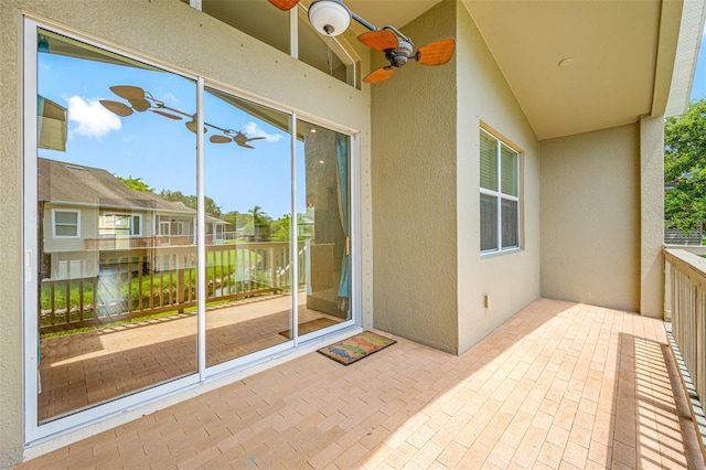 exterior space featuring a balcony and a ceiling fan