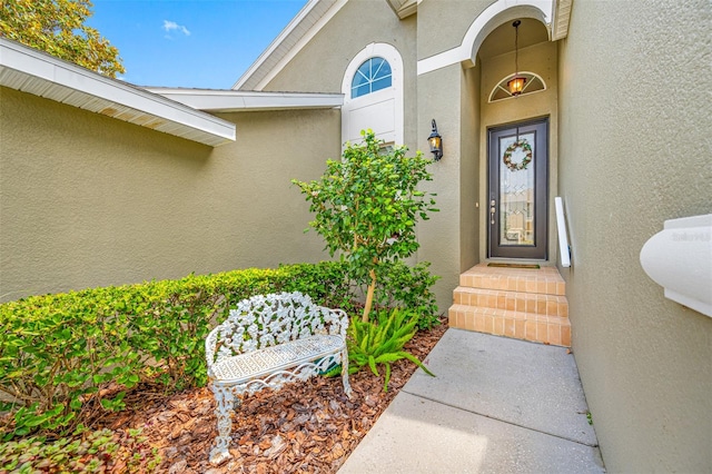 entrance to property with stucco siding