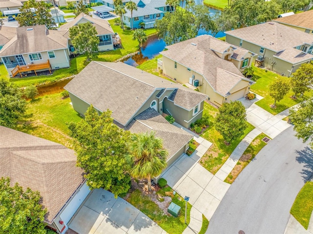 bird's eye view featuring a water view and a residential view