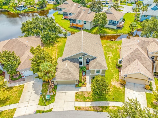 birds eye view of property featuring a residential view and a water view