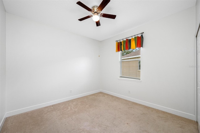 empty room featuring ceiling fan, baseboards, and carpet flooring