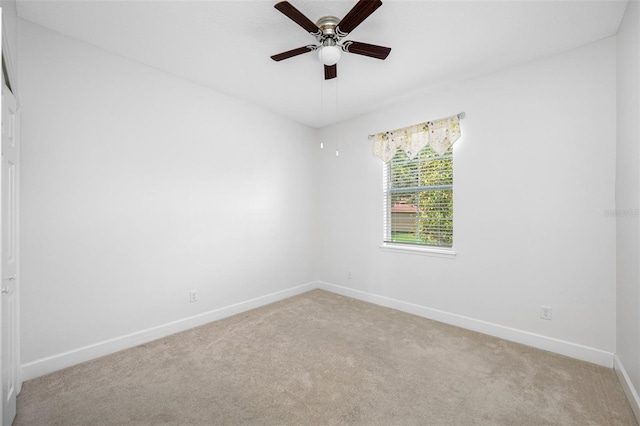 unfurnished room with baseboards, a ceiling fan, and light colored carpet