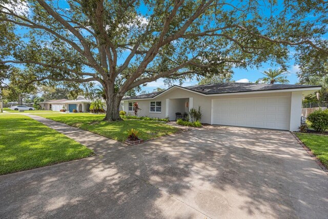 single story home with a garage and a front yard