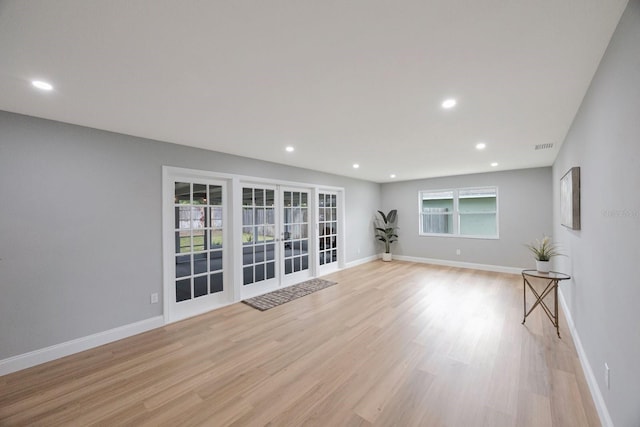 empty room with recessed lighting, baseboards, and light wood finished floors