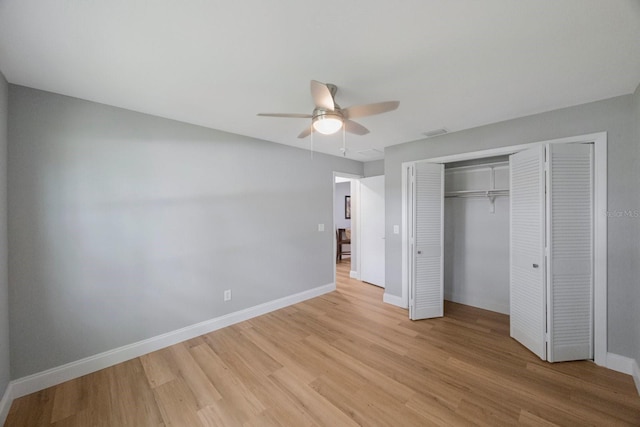 unfurnished bedroom with baseboards, a closet, visible vents, and light wood-style floors