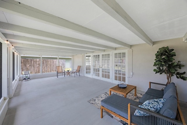 sunroom / solarium featuring beamed ceiling