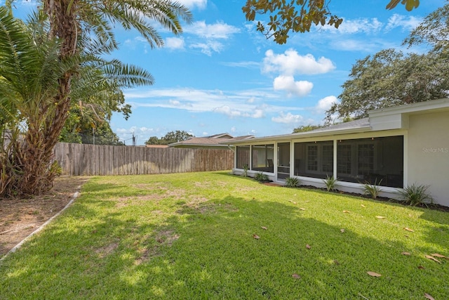 view of yard with fence and a sunroom