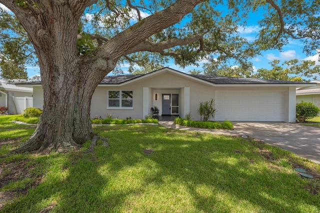 ranch-style house featuring stucco siding, an attached garage, fence, driveway, and a front lawn