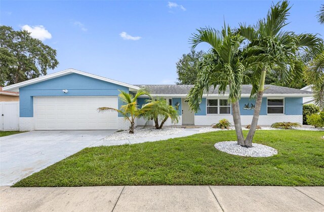 ranch-style house featuring a garage and a front yard