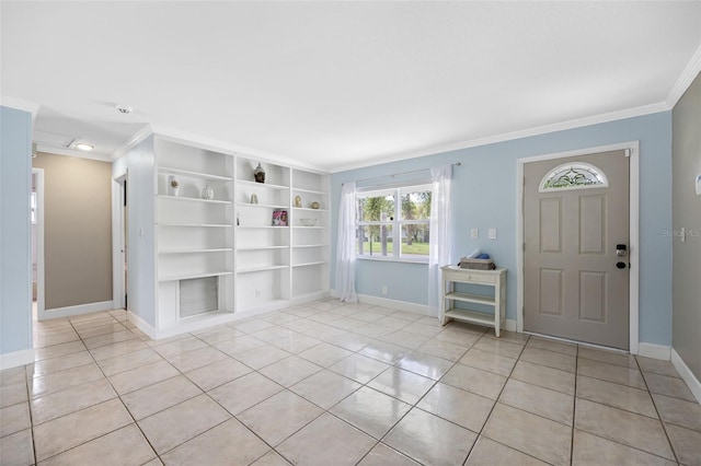 entrance foyer with light tile patterned floors, baseboards, and ornamental molding