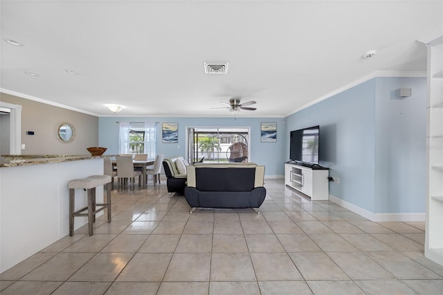 tiled living room featuring crown molding and ceiling fan