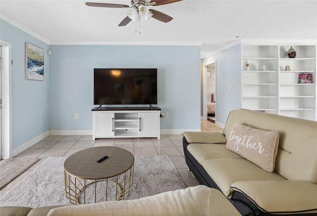 living room with light tile patterned floors, a ceiling fan, baseboards, and ornamental molding