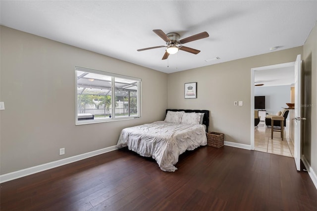 bedroom featuring visible vents, baseboards, and wood finished floors