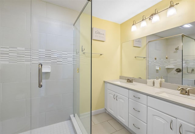 bathroom featuring tile patterned flooring, walk in shower, and vanity