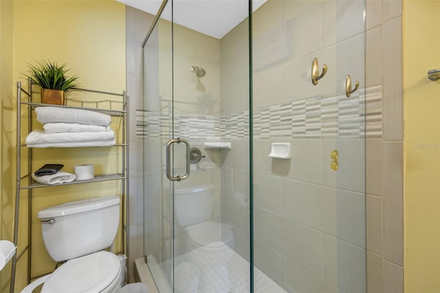 bathroom featuring a shower stall and toilet