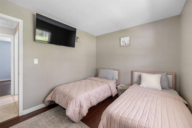 bedroom featuring baseboards and wood finished floors