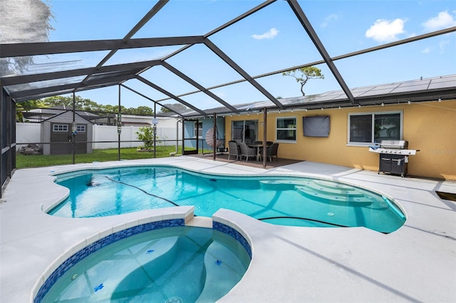 view of swimming pool featuring a patio, fence, a pool with connected hot tub, grilling area, and a lanai