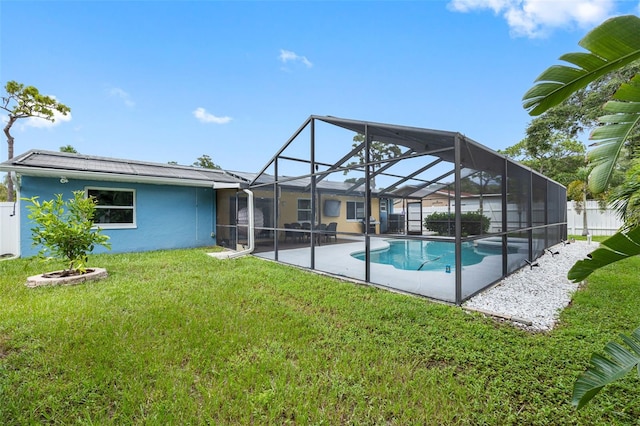 view of swimming pool with a fenced in pool, fence, a lanai, a yard, and a patio area