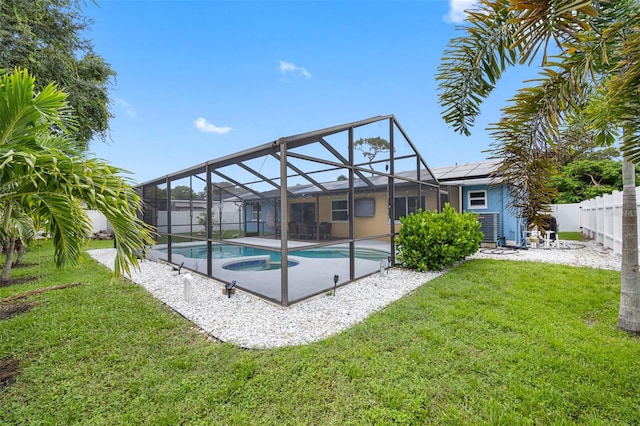 view of swimming pool with glass enclosure, a fenced in pool, a yard, fence private yard, and a patio area