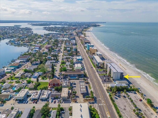 drone / aerial view featuring a beach view and a water view