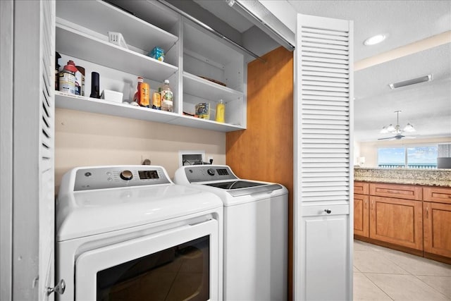 laundry area with light tile patterned floors, recessed lighting, laundry area, visible vents, and independent washer and dryer