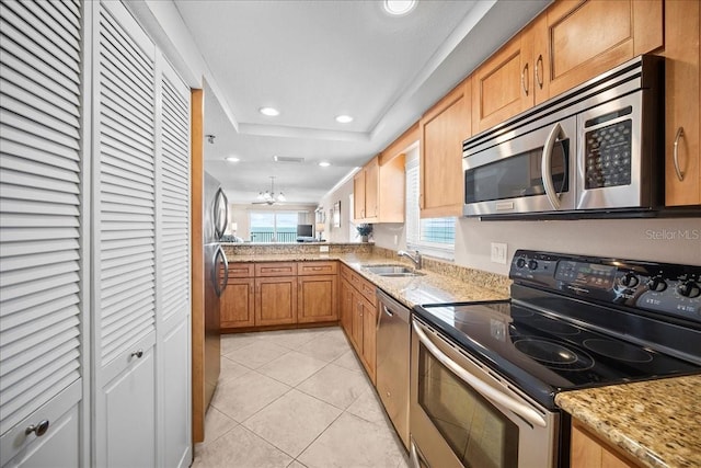 kitchen featuring light tile patterned floors, stainless steel appliances, recessed lighting, a raised ceiling, and a sink