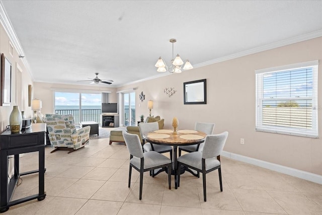 dining room featuring a fireplace, light tile patterned flooring, crown molding, and baseboards