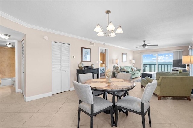 dining room with light tile patterned floors, visible vents, and ornamental molding