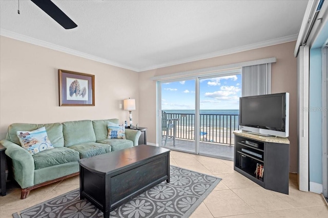 living area featuring ceiling fan, light tile patterned flooring, baseboards, and crown molding