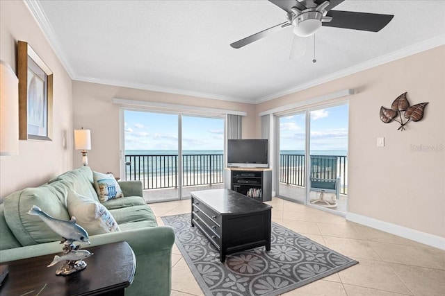 living room featuring ornamental molding, light tile patterned flooring, plenty of natural light, and baseboards