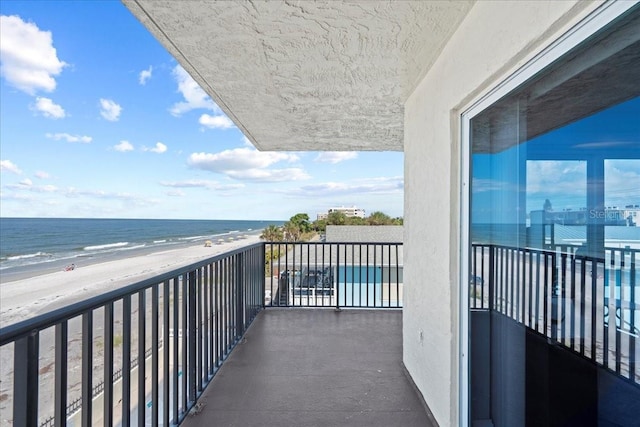 balcony with a view of the beach and a water view