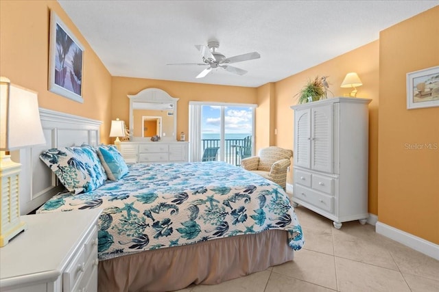 bedroom featuring a ceiling fan, access to outside, baseboards, and light tile patterned floors