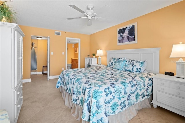 bedroom featuring baseboards, visible vents, connected bathroom, ceiling fan, and light tile patterned flooring