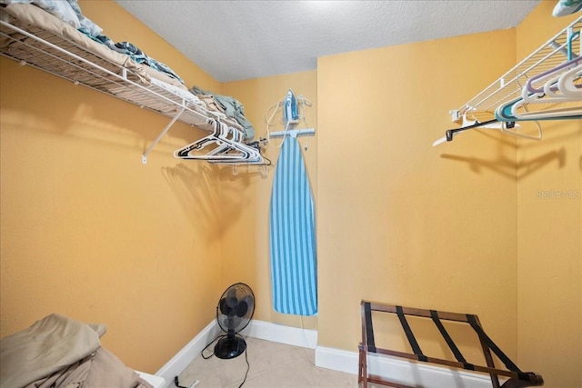 walk in closet with tile patterned floors