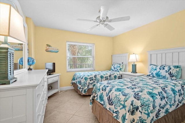 bedroom with ceiling fan, light tile patterned flooring, and baseboards