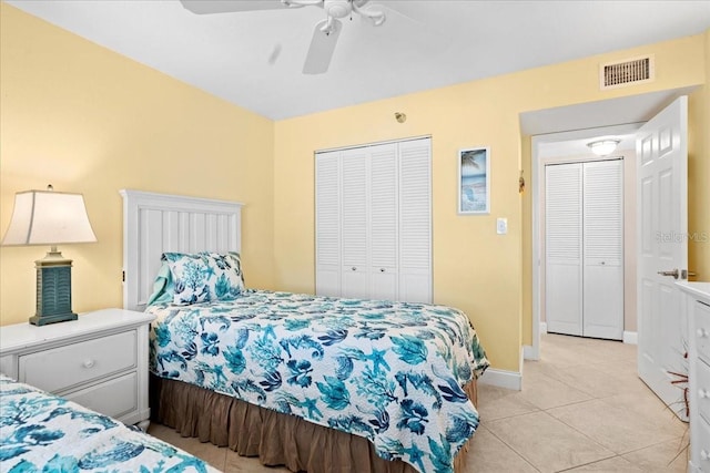 bedroom featuring light tile patterned floors, ceiling fan, visible vents, baseboards, and a closet