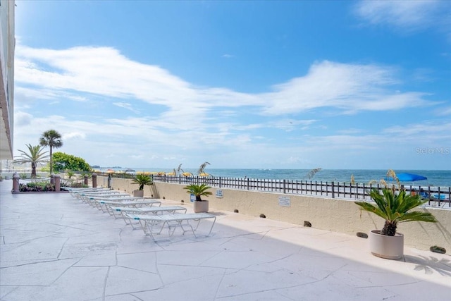 view of patio featuring a water view and a view of the beach