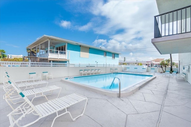 community pool featuring a patio and fence