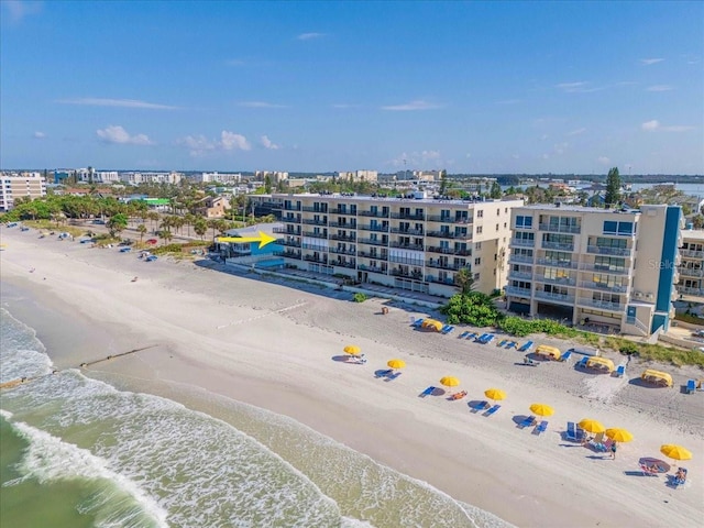 birds eye view of property with a city view, a water view, and a beach view