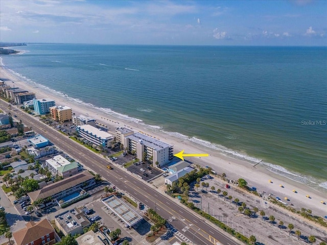 birds eye view of property with a water view and a view of the beach